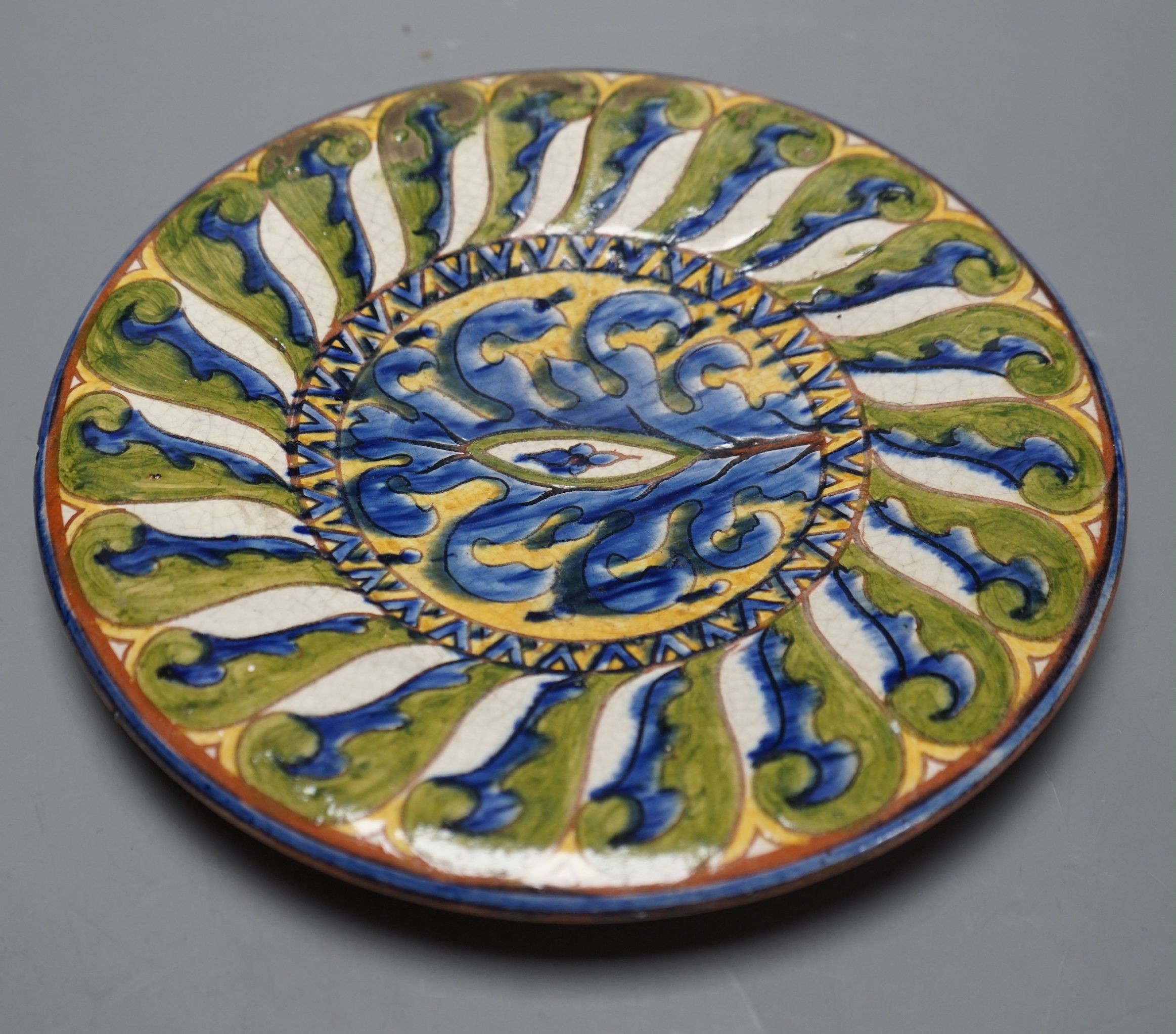 A Carlo Manzoni terracotta dish, sgraffito mark, 27cms diameter